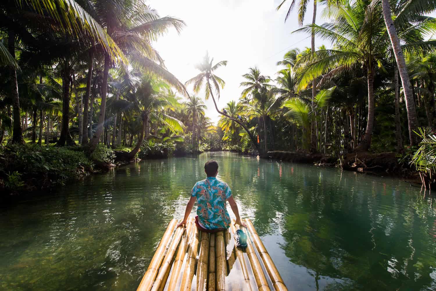 Solo travel blog image with traveller on floating raft