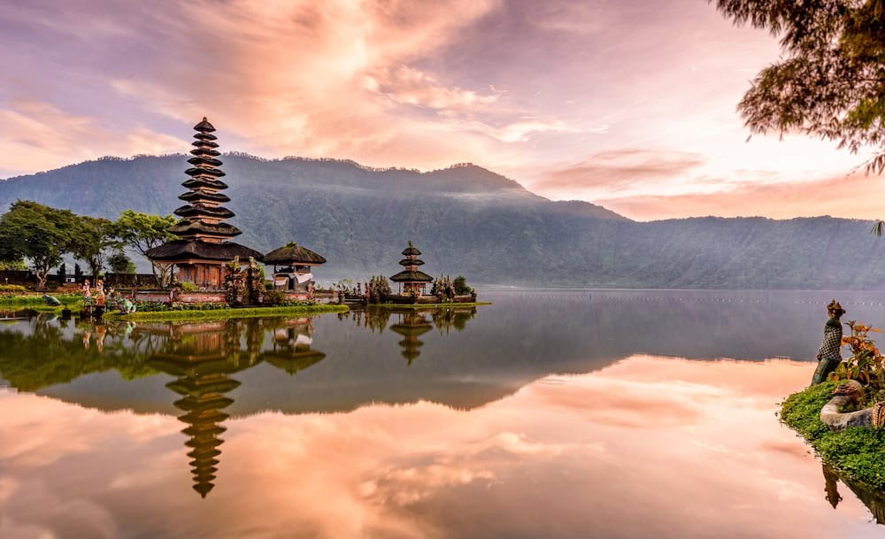 Traditional Balinese temple reflected on a calm lake in Bali, showcasing the island’s spiritual culture and natural beauty