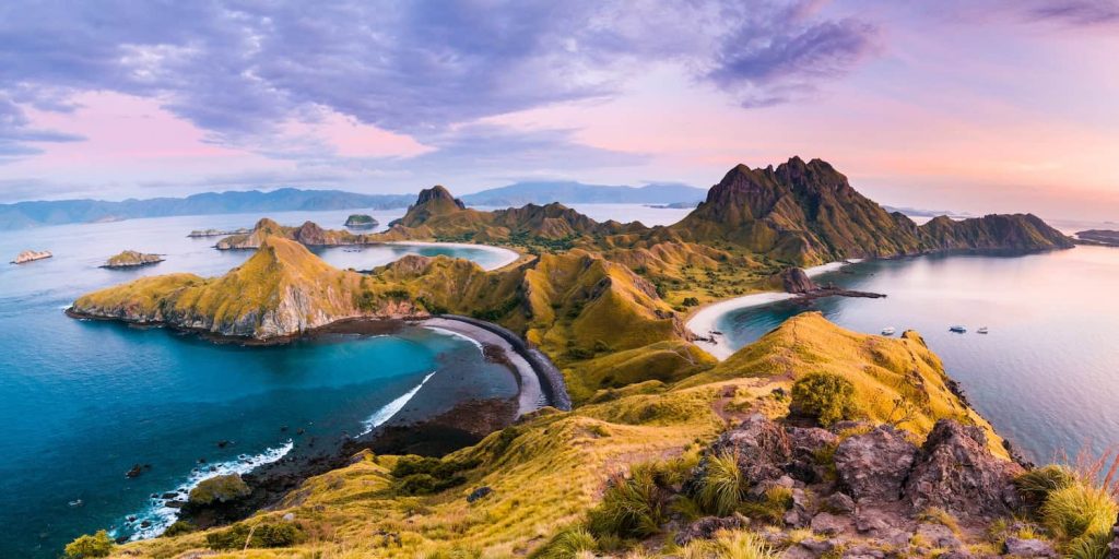 Panoramic coastal landscape of Flores Island Indonesia, with rugged hills, turquoise bays, and dramatic shorelines