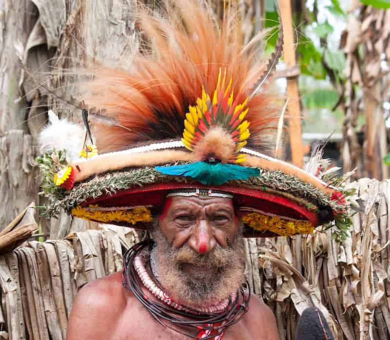 Portrait of a Huli wigman wearing a traditional feathered headdress in Papua New Guinea