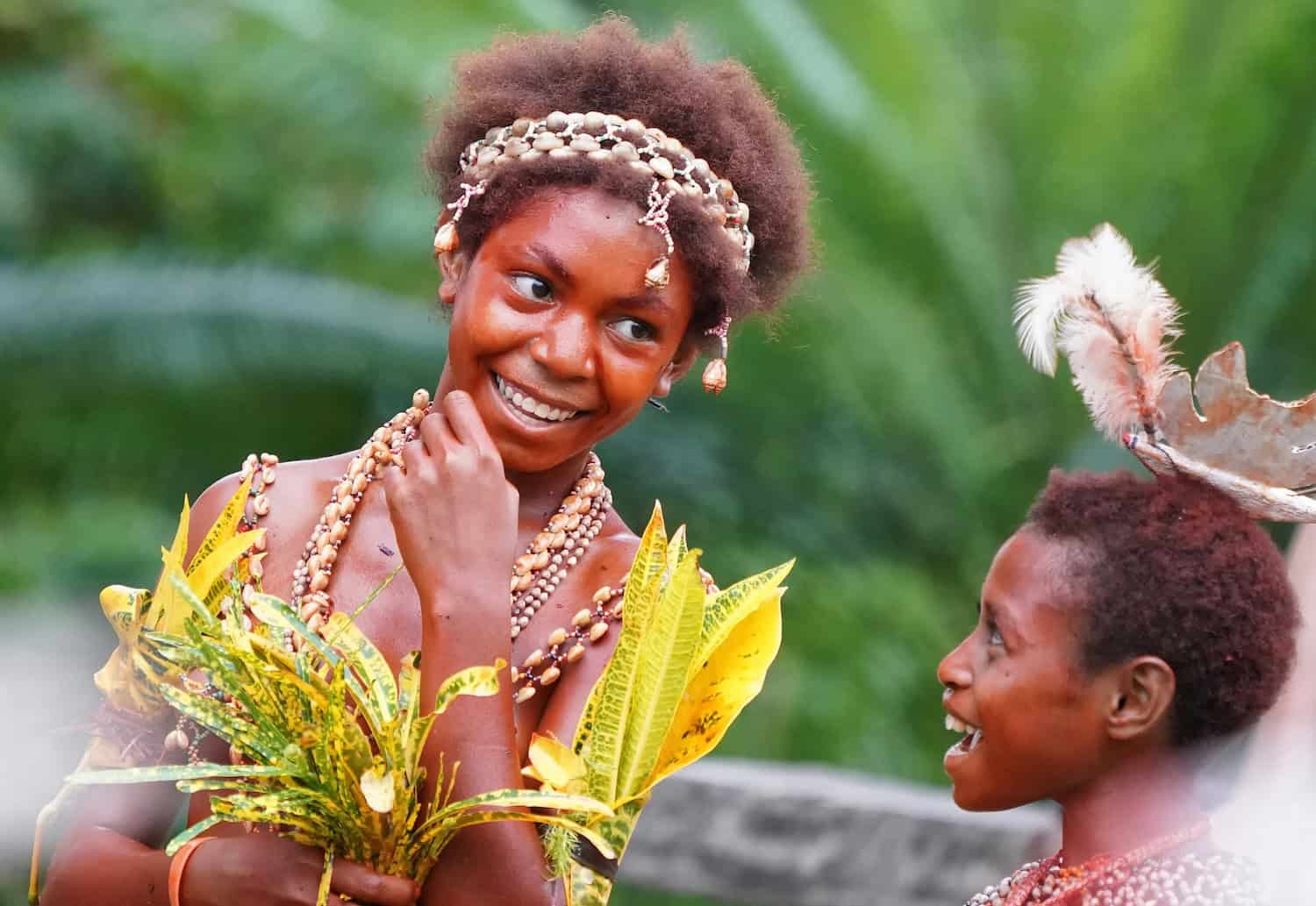 Children wearing traditional shell jewellery and leaf adornments in Papua New Guinea