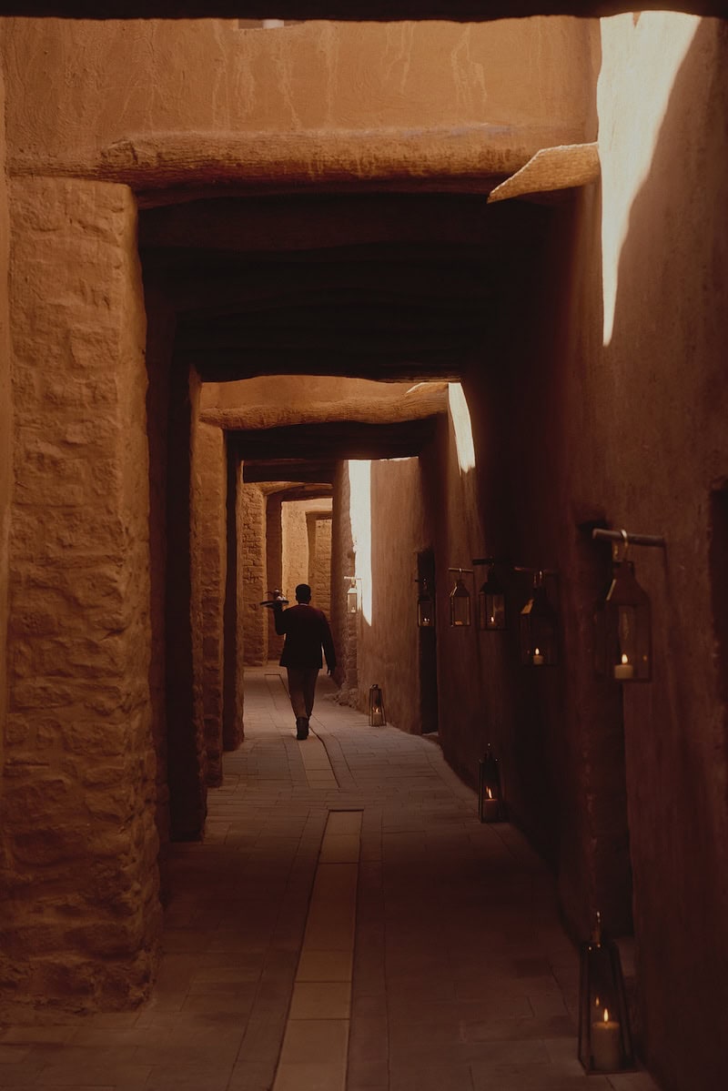 Candlelit courtyard passage at Dar Tantora – The House Hotel, AlUla