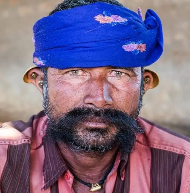 Portrait of a man from the Bharwad pastoral community in Muli, Gujarat, wearing a traditional blue turban